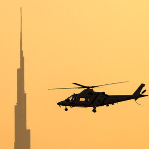 Dubai Police Agusta A-109K-2 in flight at sunset — United Arab Emirates