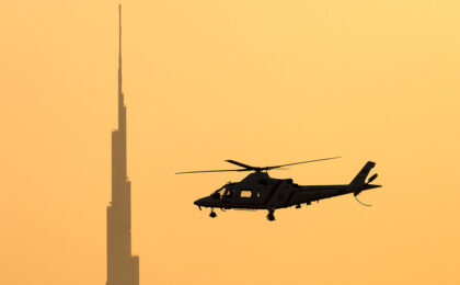 Dubai Police Agusta A-109K-2 in flight at sunset — United Arab Emirates