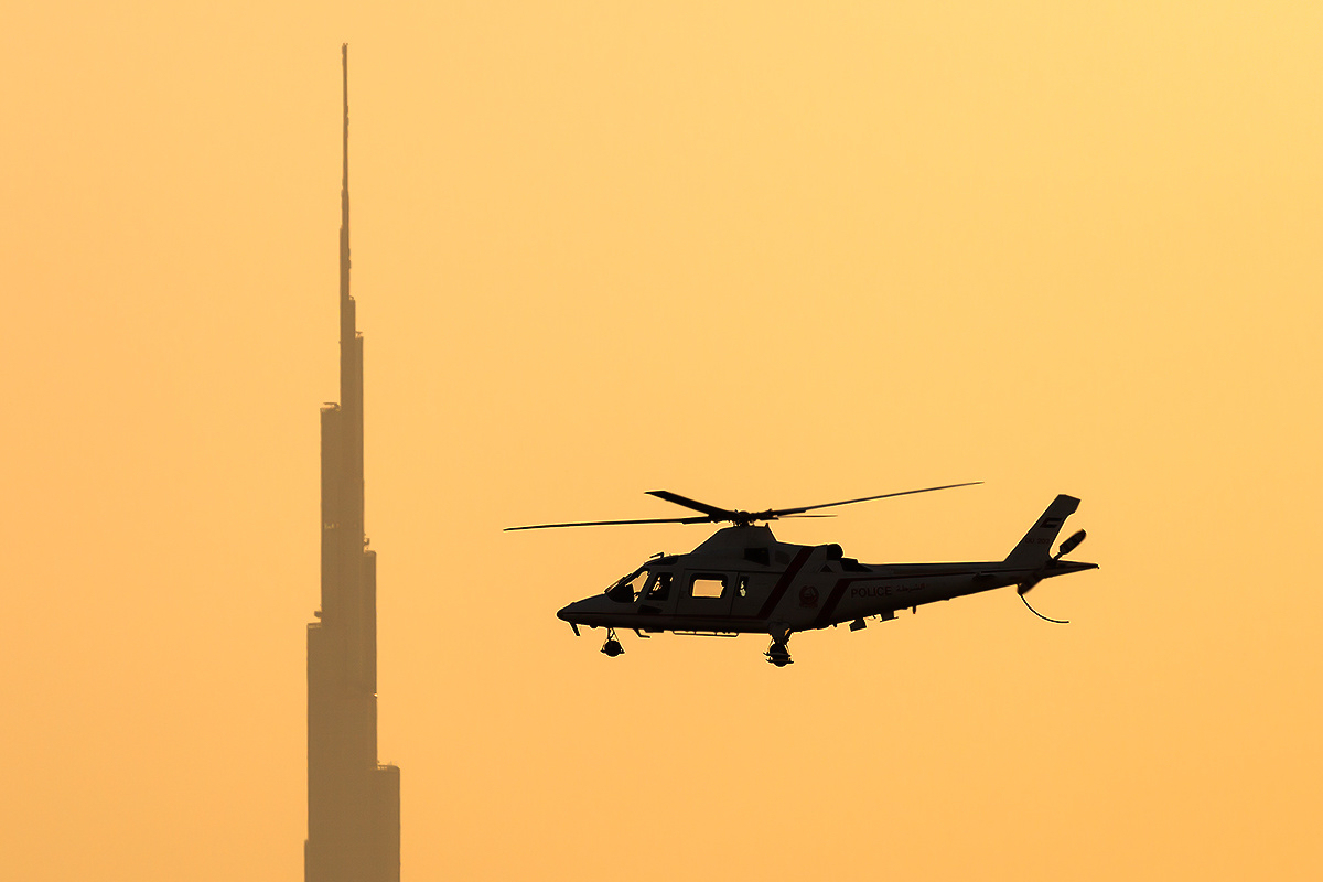 Dubai Police Agusta A-109K-2 in flight at sunset — United Arab Emirates